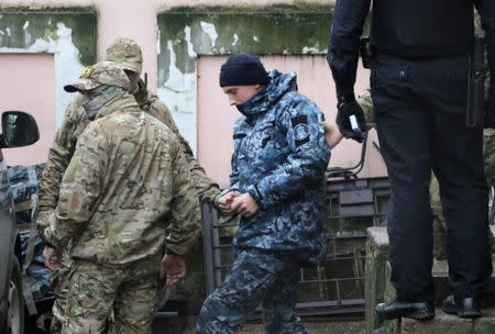 FILE PHOTO: Members of Russia's FSB security service escort a detained Ukrainian navy sailor (C) after a court hearing in Simferopol, Crimea November 27, 2018. REUTERS/Pavel Rebrov/File Photo