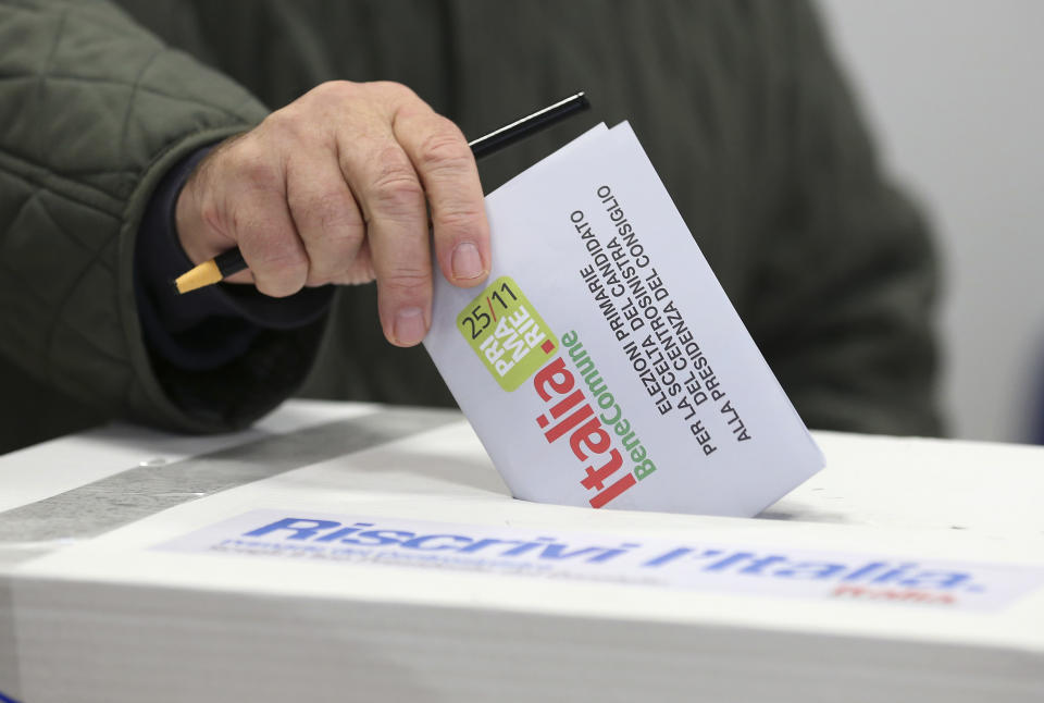 A man casts his vote during a primary runoff, in Piacenza, Italy, Sunday, Dec. 2, 2012. Italians are choosing a center-left candidate for premier for elections early next year, an important primary runoff given the main party is ahead in the polls against a center-right camp in utter chaos over whether Silvio Berlusconi will run again. Sunday's runoff pits veteran center-left leader Pier Luigi Bersani, 61, against the 37-year-old mayor of Florence, Matteo Renzi, not shown, who has campaigned on an Obama-style "Let's change Italy now" mantra. (AP Photo/Antonio Calanni)