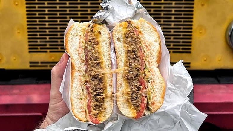 chopped cheese sandwich cut in two