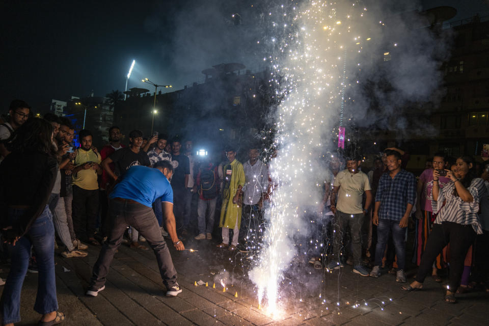 Indian cricket fans light crackers outside the Wankhade Stadium as they celebrate their team's victory in the ICC Cricket World Cup semi-final match against New Zealand in Mumbai, India, Wednesday, Nov. 15, 2023. (AP Photo/Altaf Qadri)