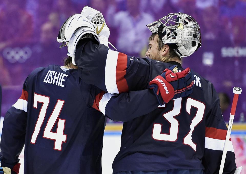 United States forward T.J. Oshie (74) congratulates United States goalie Jonathan Quick (37) after defeating Russia 3-2 in a shootout in a men's ice hockey game at the 2014 Winter Olympics, Saturday, Feb. 15, 2014, in Sochi, Russia. (AP Photo/The Canadian Press, Nathan Denette)