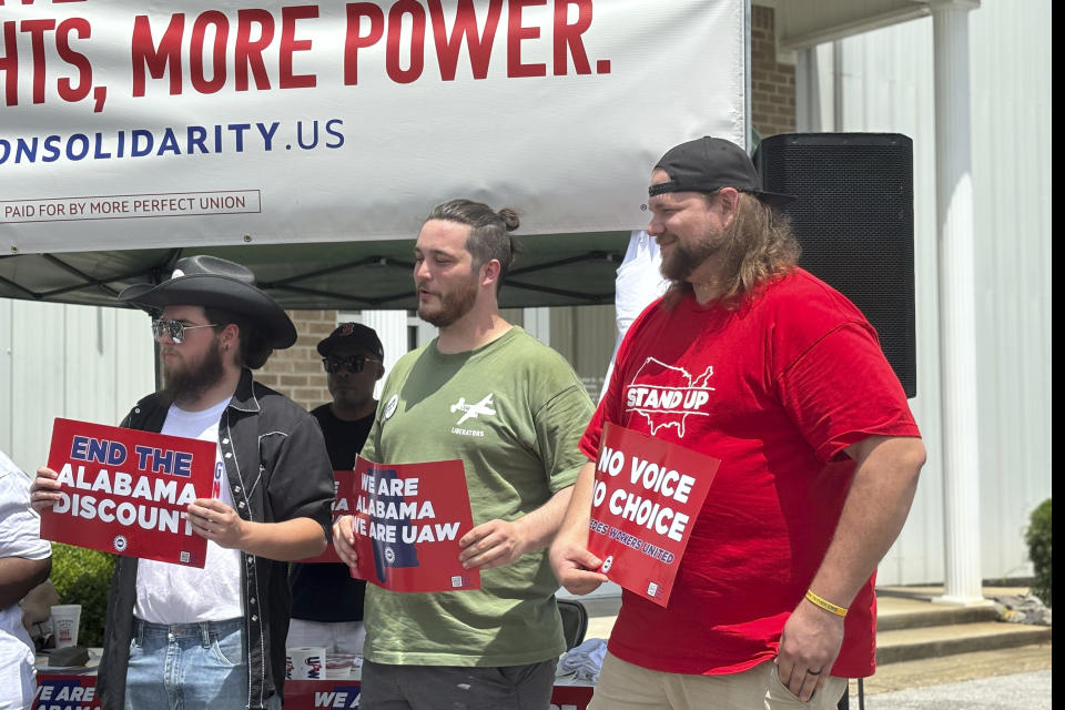 Mercedes employees Austin Brooks, David Johnston and Jacob Ryan attend a rally in Tuscaloosa, Ala., May 5, 2024. A month after workers at a Volkswagen factory in Tennessee overwhelmingly voted to unionize, the United Auto Workers is aiming for a key victory at Mercedes-Benz in Alabama. More than 5,000 workers at the facility in Vance and nearby battery plant will vote next week on whether to join the UAW. (AP Photo/Kim Chandler)