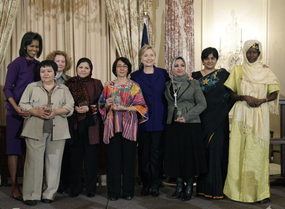 FILE - In this March 11, 2009 file photo, prominent Afghan women’s rights activist Wazhma Frogh, fourth from left, joins First lady Michelle Obama, left, Mutabar Tadjibayeva, from Uzbekistan, Veronika Marchenko, from Russia,Norma Cruz, from Guatemala, Secretary of State Hillary Rodham Clinton, Suaad Abbas Salman Allami, from Iraq, Ambiga Sreenevasan, from Malaysia and Hadizatou Mani, from Niger for a photograph at the International Women of Courage Award Ceremony at the State Department in Washington. Prominent Afghan women’s rights activist, Wazhma Frogh was denied a visa from the U.S in 2013 because they feared she would overstay. But she said she neither wanted asylum nor to overstay her visa, only a respite from an Afghan commander’s harassment. (AP Photo/Alex Brandon, File)