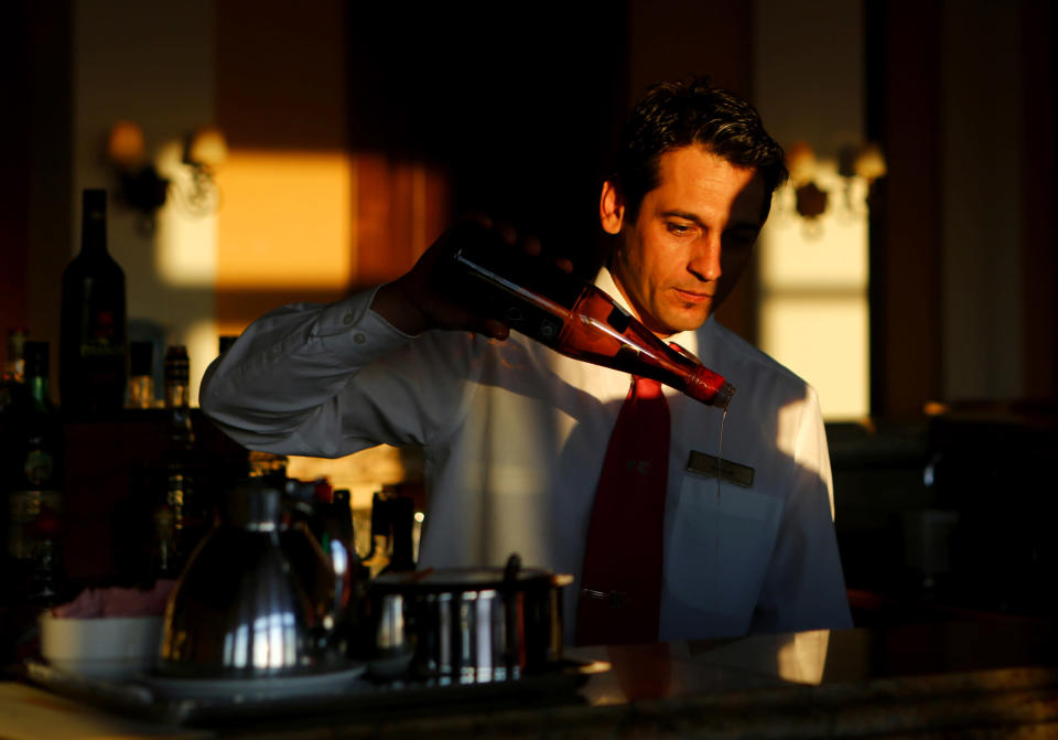 Vassilis Vassilakis prepares drinks at the bar of the Olympia Oasis Hotel at the Olympia Riviera resort in the town of K... Yannis Behrakis / Reuters