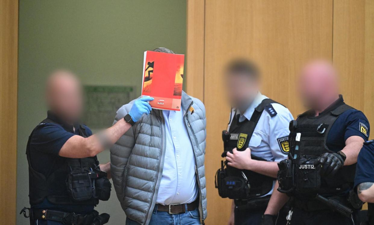<span>One of nine suspected participants in the coup plot is brought to the courtroom in Stuttgart on Monday.</span><span>Photograph: Bernd Weissbrod/AFP/Getty Images</span>