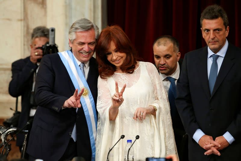 Argentina's President Alberto Fernandez and Vice President Cristina Fernandez de Kirchner flash V-signs after they were sworn in, in Buenos Aires