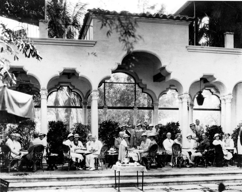 Fashionably-dressed members of the Everglades Club gather in the shaded perimeter of the Marble Patio, which today is paved with green terrazzo. Date unknown, probably 1920s.