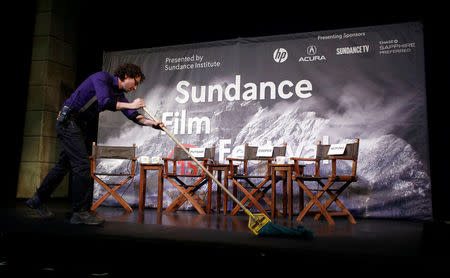 Kevin Kane prepares the stage at an opening day news conference for the Sundance Film Festival in Park City, Utah, in this January 22, 2015 file photo. REUTERS/Jim Urquhart/File Photo