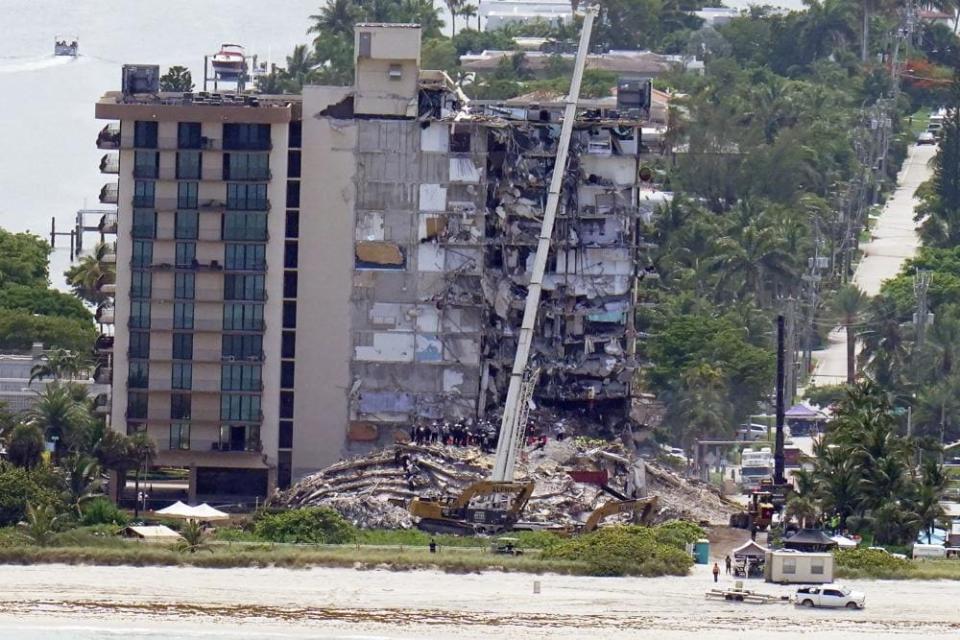 Workers search in the rubble at the Champlain Towers South Condo, Saturday, June 26, 2021, in Surfside, Fla. (AP Photo/Gerald Herbert)