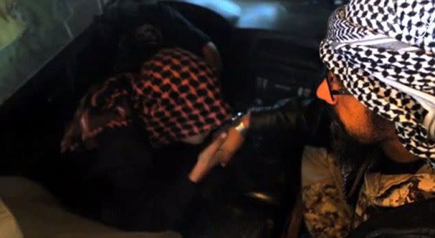 Disturbing video footage has emerged of an 11-year-old child jihadi kneeling before his father's outstretched hand and kissing it before blowing himself up in a suicide blast near Aleppo, Syria. Photo: YouTube