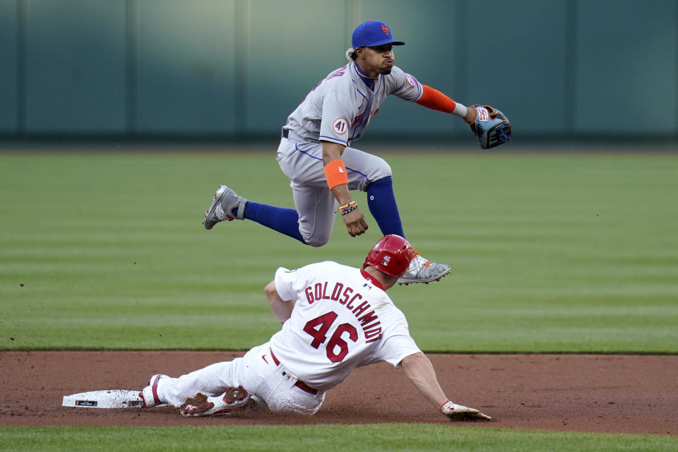 St. Louis Cardinals' Paul Goldschmidt (46) is out at second as New York Mets shortstop Francisco Lindor turns the double play during the first inning of a baseball game Monday, May 3, 2021, in St. Louis. The Cardinals' Nolan Arenado was out at first. (AP Photo/Jeff Roberson)