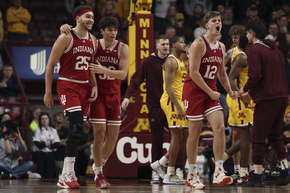 Indiana forward Race Thompson (25), guard Trey Galloway (32) and forward Miller Kopp (12) react after a play against Minnesota during the second half of an NCAA college basketball game Wednesday, Jan. 25, 2023, in Minneapolis. Indiana won 61-57. (AP Photo/Stacy Bengs)
