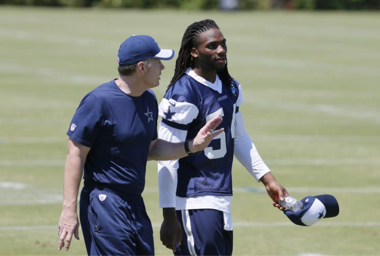 Jaylon Smith walks off the practice field with Cowboys linebackers coach Matt Eberflus. (AP)