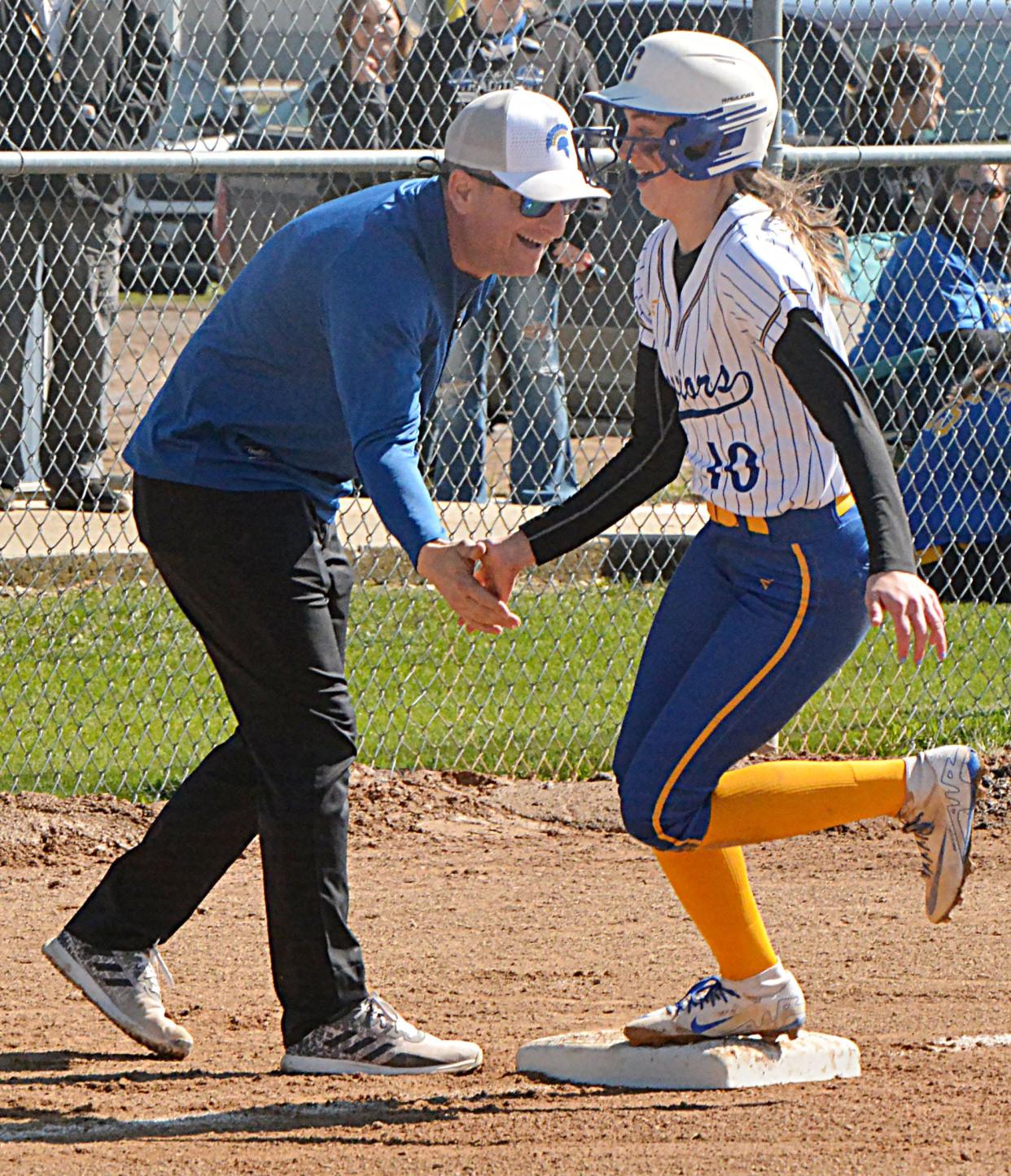 Castlewood's Cydni Kudrna is congratulated by coach Craig Horn after she clobbered a solo homer during a high school fastpitch tripleheader on Saturday, May 4, 2024 in Castlewood.