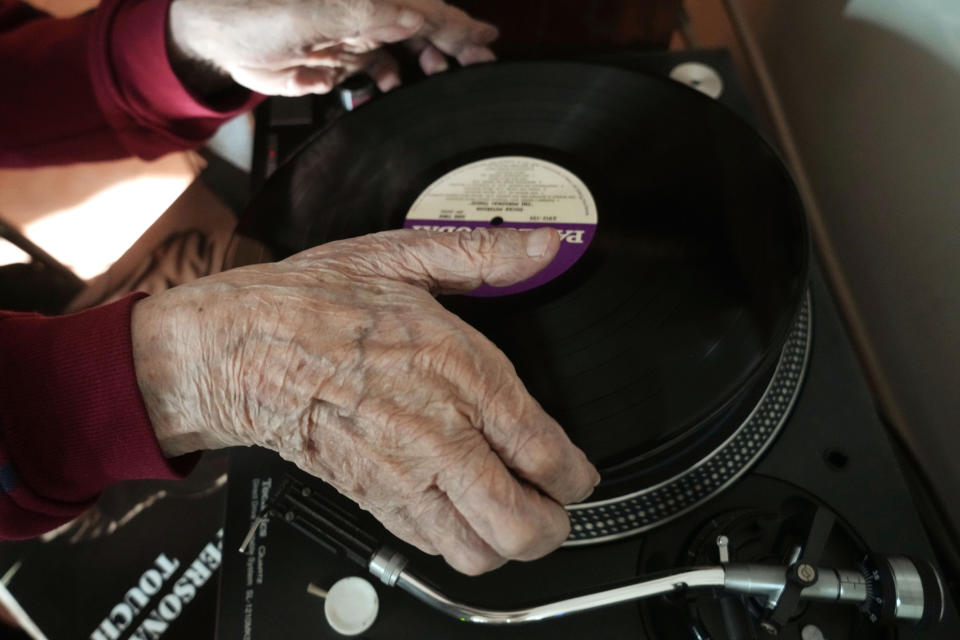 FILE - Ray Cordeiro, Hong Kong's oldest DJ, plays music at his home in Hong Kong, Thursday, May 27, 2021. Cordeiro, who interviewed music acts including the Beatles during a six-decade career on Hong Kong radio that earned him the title of the world's longest-working disc jockey, died Friday, Jan. 13, 2023, his former employer announced. He was 98. (AP Photo/Kin Cheung, File)