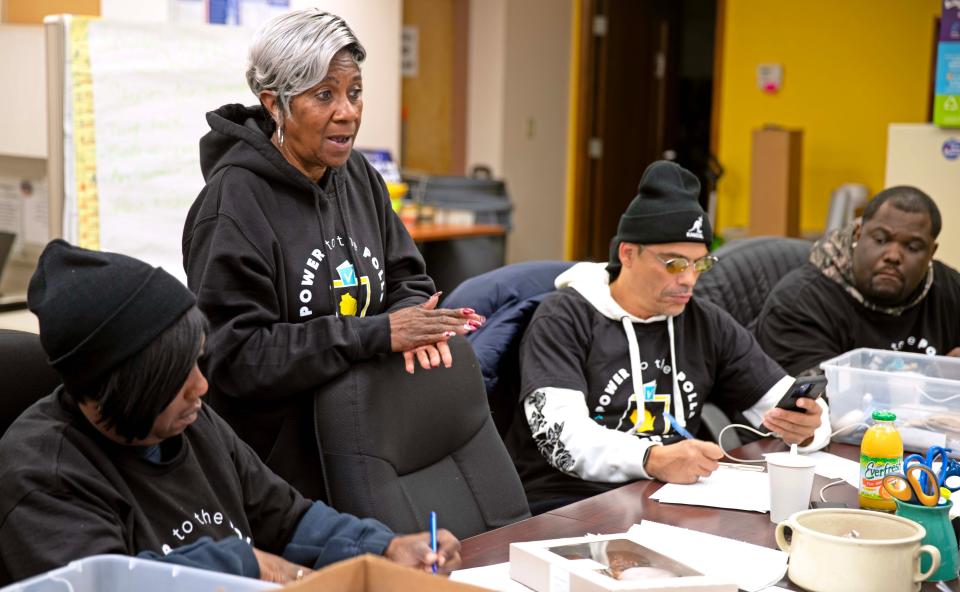 Calena Roberts leads a group meeting of canvassers at the offices of Power to the Polls on November 18, in Milwaukee.