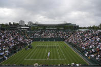 Argentina's Federico Delbonis serves to Russia's Andrey Rublev during the men's singles match on day one of the Wimbledon Tennis Championships in London, Monday June 28, 2021. (AP Photo/Alberto Pezzali)