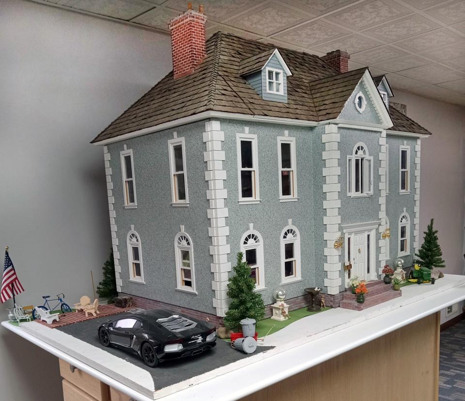 Built by Leigh Michaels and husband Michael Lemberger, this dollhouse is a one-inch to the foot scale model of a Georgian house with stone facing, cedar shake shingles, hardwood floors, and period furniture. If real, it would be 3,200 square feet with three bedrooms and two baths.