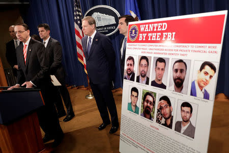 U.S. Deputy Attorney General Rod Rosenstein speaks at a news conference with other law enforcement officials at the Justice Department to announce nine Iranians charged with conducting massive cyber theft campaign, in Washington, U.S., March 23, 2018. REUTERS/Yuri Gripas