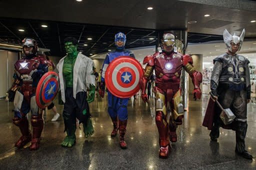 Participants wearing super heroes costumes walk in line during the 14th Ani-Com and Games exhibition in Hong Kong. One of Asia's biggest animation and comic fairs opened Friday in Hong Kong, attracting thousands of fans and bringing some fun back into super heroes after the Batman movie shootings in Colorado. AFP PHOTO / Philippe Lopez