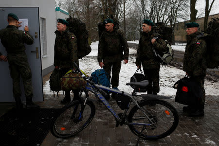 Damian Krasnodebski, 27, an architect, and other recruits check in at a barrack on their first day of 16-day basic training for Poland's Territorial Defence Forces, at a military unit in Siedlce, Poland, December 1, 2017. REUTERS/Kacper Pempel/Files