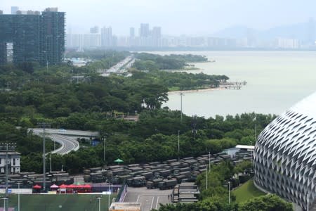 FILE PHOTO: Chinese paramilitary vehicles are parked at the Shenzhen Bay Sports Center