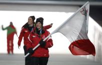 Malta's flag-bearer Elise Pellegrin leads her country's contingent during the opening ceremony of the 2014 Sochi Winter Olympics, February 7, 2014. REUTERS/Phil Noble (RUSSIA - Tags: OLYMPICS SPORT)