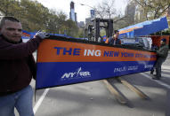 Workers assemble the finish line for the New York City Marathon in New York's Central Park, Thursday, Nov. 1, 2012. The 43rd New York City Marathon is on Sunday, with many logistical questions to be answered. The crane atop a high rise that collapsed during superstorm Sandy is visible at background center.(AP Photo/Richard Drew)Workers assemble the finish line for the New York City Marathon in New York's Central Park, Thursday, Nov. 1, 2012. The New York City Marathon is on Sunday, with many logistical questions to be answered. (AP Photo/Richard Drew)