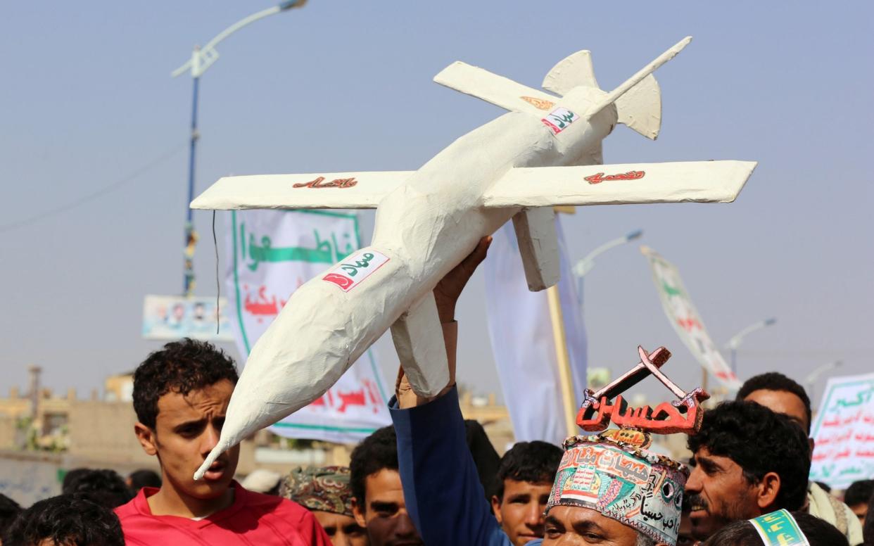 Followers of the Houthi movement carry a mock drone during a rally on September 10 - REUTERS