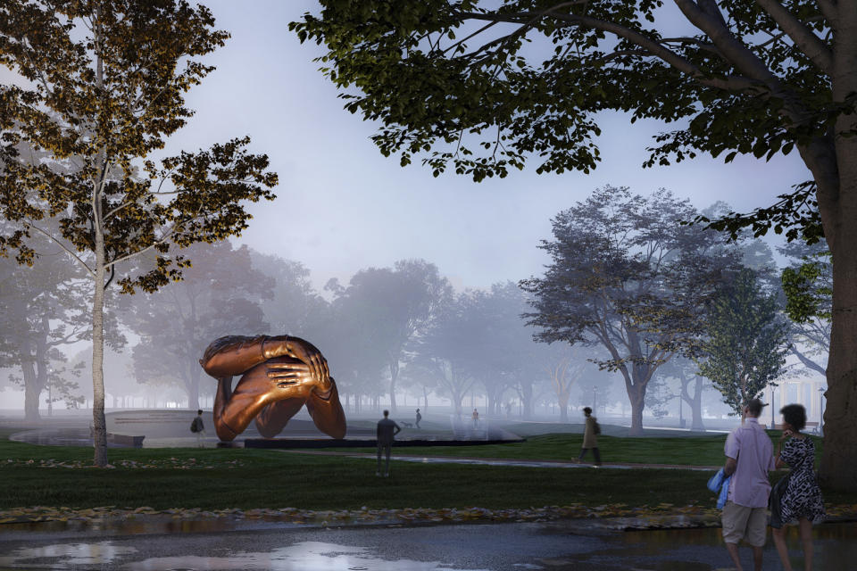 This computer rendering provided by Mass Design Group, shows a memorial to Dr. Martin Luther King Jr. and Coretta Scott King, a 20-foot-high (6-meter-high) bronze sculpture called “The Embrace", planned for the Boston Common in Boston. The memorial has received unanimous approval from a city panel, allowing construction to start, the group behind the memorial said Wednesday, May 26, 2021. (Mass Design Group via AP)