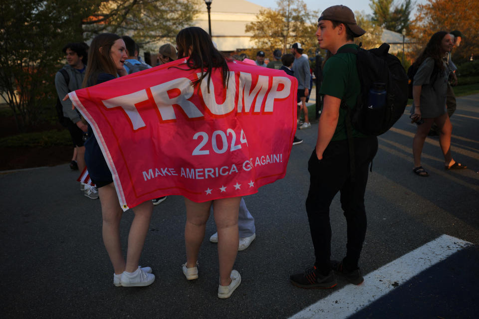 Supporters of Republican presidential candidate and former U.S. President Donald Trump gather outside the venue where Trump took part in a CNN campaign town hall event in Manchester, New Hampshire on May 10, 2023. / Credit: Brian Snyder/Reuters