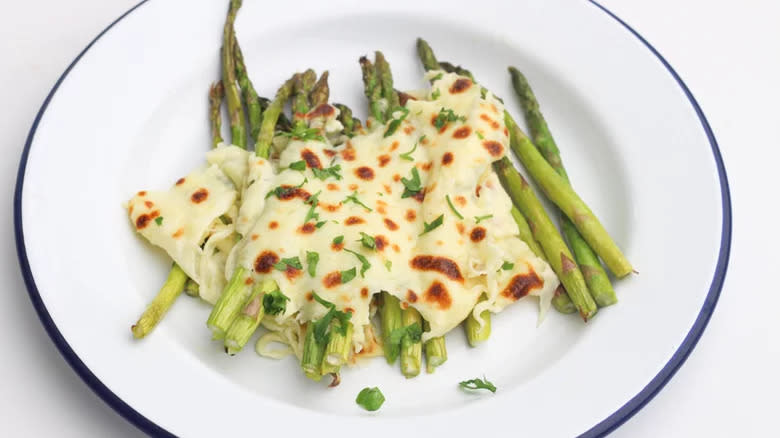 Asparagus with melted cooked cheese