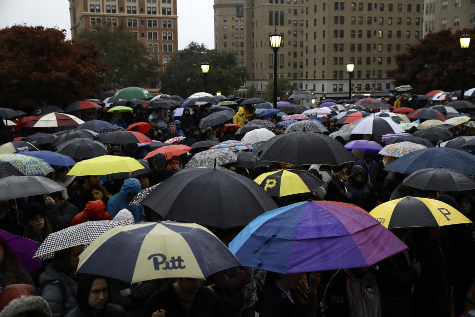 People stand outside the Soldiers & Sailors Memorial Hall & Museum due to over-capacity and listen via speakers to a community gathering inside, Sunday, Oct. 28, 2018, in Pittsburgh, in the aftermath of the deadly shooting at the Tree of Life Synagogue a day earlier. (AP Photo/Matt Rourke)