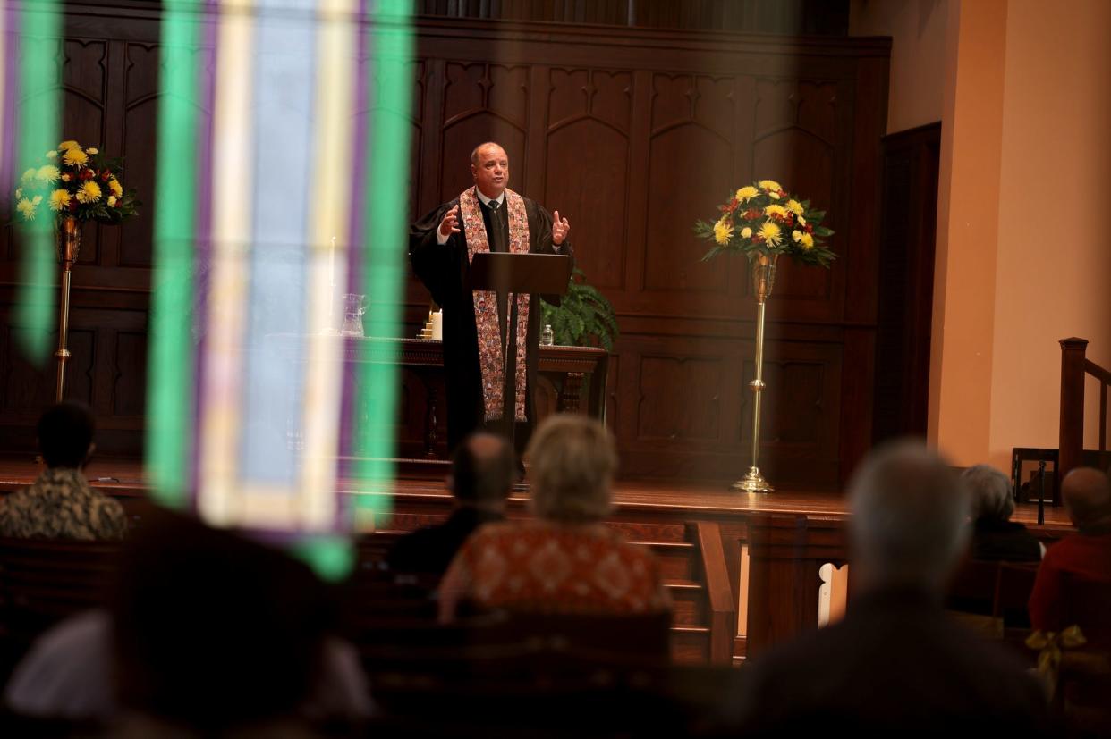FILE - Stained glass is reflected off a window as Rev. Billy Hester delivers his sermon on "The Blessings of Dependence" at Asbury Memorial.