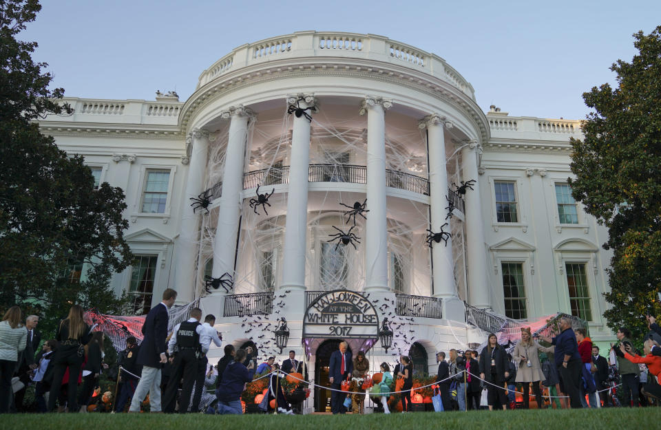 <p>President Donald Trump and first lady Melania Trump hand out treats as they welcome children from the Washington area and children of military families to trick-or-treat celebrating Halloween at the South Lawn of the White House in Washington, Oct. 30, 2017. (Photo: Pablo Martinez Monsivais/AP) </p>