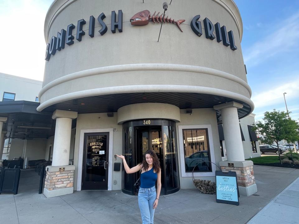 The writer poses in front of Bonefish Grill