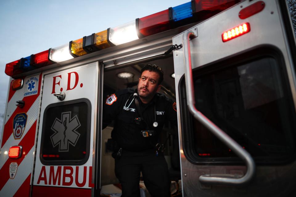 In this April 23, 2020, photo FDNY paramedic Alex Tull, who has recently recovered from COVID-19, prepares to begin his shift outside EMS station 26, the "Tinhouse", in the Bronx borough of New York. (AP Photo/John Minchillo)