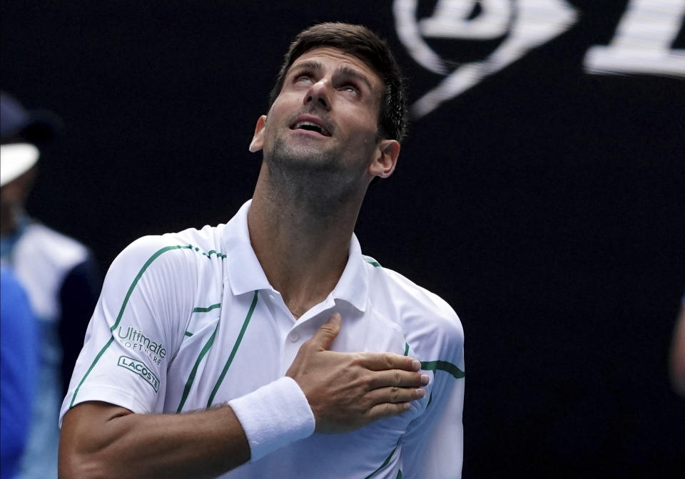 Serbia's Novak Djokovic celebrates after defeating Diego Schwartzman of Argentina in their fourth round singles match at the Australian Open tennis championship in Melbourne, Australia, Sunday, Jan. 26, 2020. (AP Photo/Lee Jin-man)