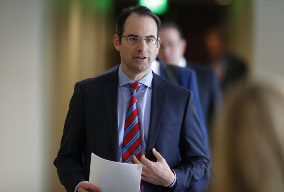 Colorado Attorney General Phil Weiser heads into news conference to speak about the plan to have a former federal prosecutor review the sexual abuse files of Colorado's Roman Catholic dioceses, Tuesday, Feb. 19, 2019, in Denver. The church will pay reparations to victims under a voluntary joint effort with the state attorney general. (AP Photo/David Zalubowski)