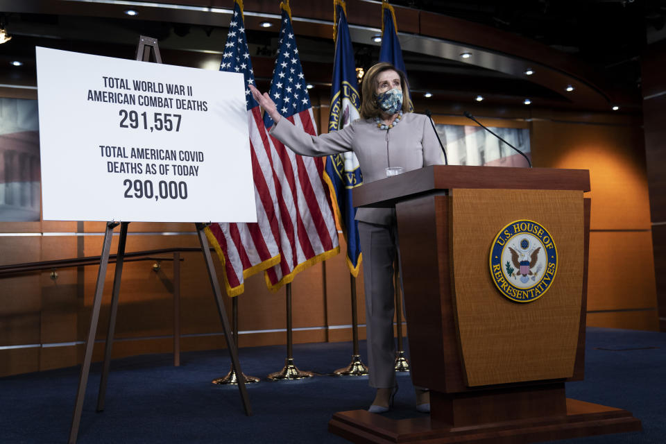 House Speaker Nancy Pelosi gestures to a sign noting the American COVID-19 death toll during her weekly news conference on Capitol Hill Thursday. (Photo by Drew Angerer/Getty Images)