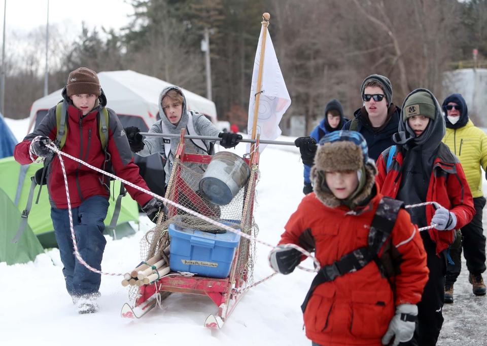 Members of Scout Troop 506 of Medina move their sled across the snow to the next event in Klondike 2022, an endurance challenge with sleds across the snow and tests the scouts skills in several events including knot tying and teamwork at Camp Manatoc in Peninsula on Saturday. 