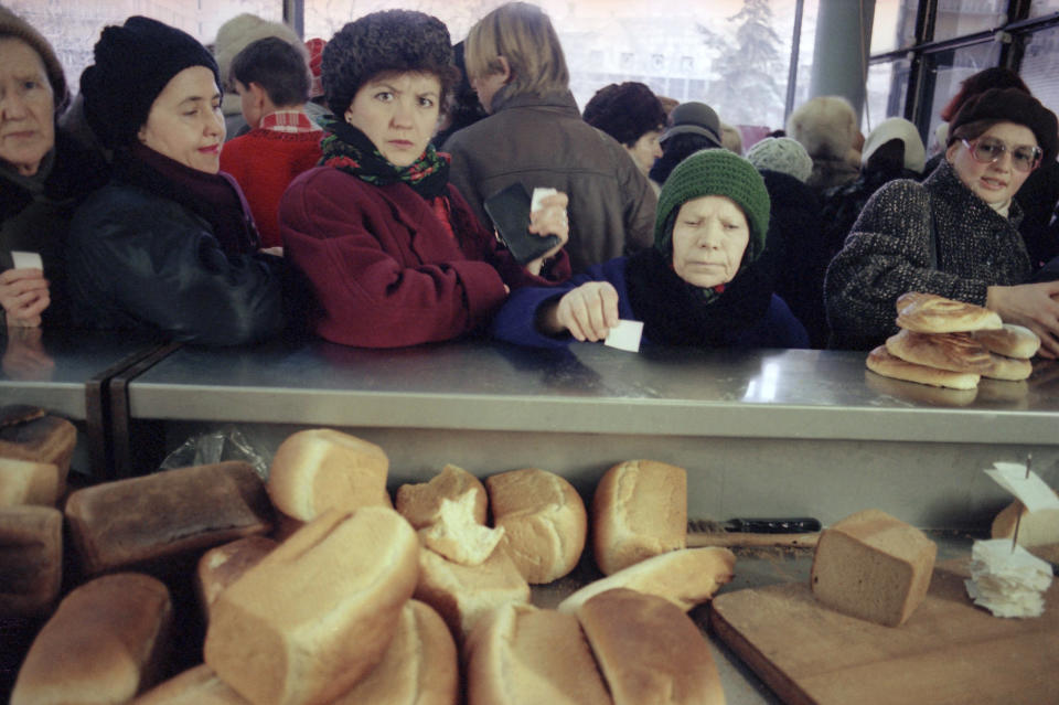 FILE - Several women wait with their tickets in hand, for fresh bread at a bakery in Moscow, Monday, Dec. 23, 1991. By the fall of 1991, however, deepening economic woes and secessionist bids by Soviet republics had made the collapse all but inevitable. The failed August 1991 coup by the Communist old guard was a major catalyst, dramatically eroding Gorbachev’s authority and encouraging more republics to seek independence. (AP Photo/Gene Berman, File)