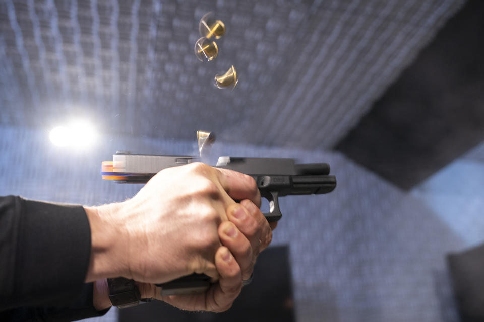 A semi-automatic pistol with a conversion device installed making it fully automatic is fired as four empty shell casings fly out of the weapon, at the Bureau of Alcohol, Tobacco, Firearms, and Explosives (ATF), National Services Center, Thursday, March 2, 2023, in Martinsburg, W.Va. Machine guns have been illegal in the U.S. for decades, but in recent years the country has seen a new surge of weapons capable of automatic fire. Small pieces of plastic or metal used to convert legal guns into homemade machine guns are helping to fuel gun violence. (AP Photo/Alex Brandon)