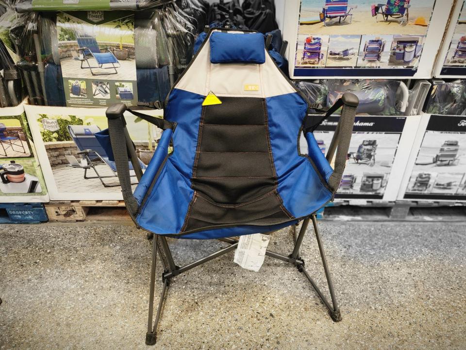 A blue and black foldable hammock on the floor at Costco