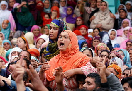 Women react as they watch the body of Kashmiri professor Mohammad Rafi Bhat, a suspected militant, after he was killed in a gunbattle with Indian security forces in south Kashmir, during his funeral procession at Chunduna village in Ganderbal district May 6, 2018. REUTERS/Danish Ismail