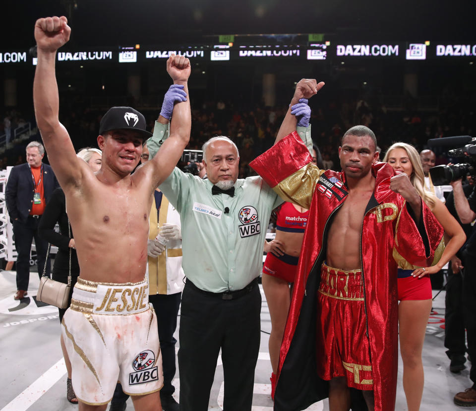 Thomas Dulorme, right, and Jessie Vargas celebrate after the WBC silver welterweight title boxing match Saturday, Oct. 6, 2018, in Chicago. The fight ended in a draw. (AP Photo/Kamil Krzaczynski)
