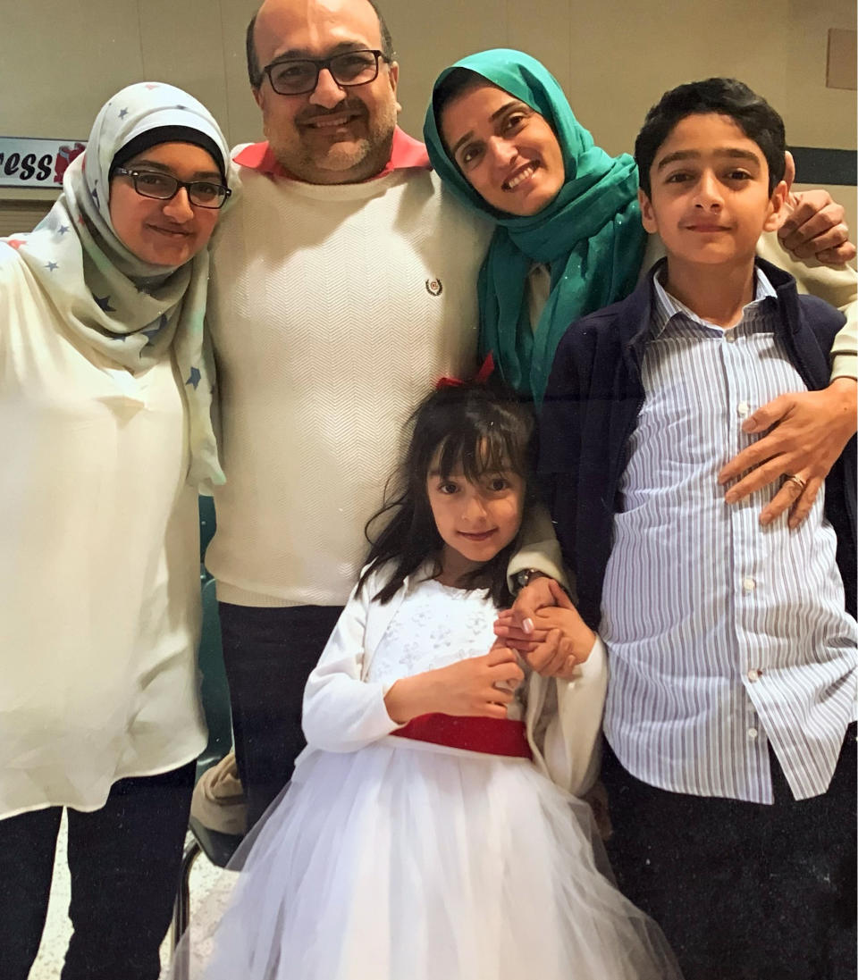 In this undated photo provided by David Oates, Dr. Hasan Gokal, second left, is pictured with his wife, two daughters and son. A grand jury on Wednesday, June 30, 2021, declined to indict Gokal, the former Houston-area Harris County Public Health doctor who was accused of stealing nine doses of coronavirus vaccine from a damaged vial and administering them to family and friends. In an interview with The Associated Press, Gokal said his decision “was the right thing to do and it meant saving more lives.” (Courtesy of David Oates via AP)