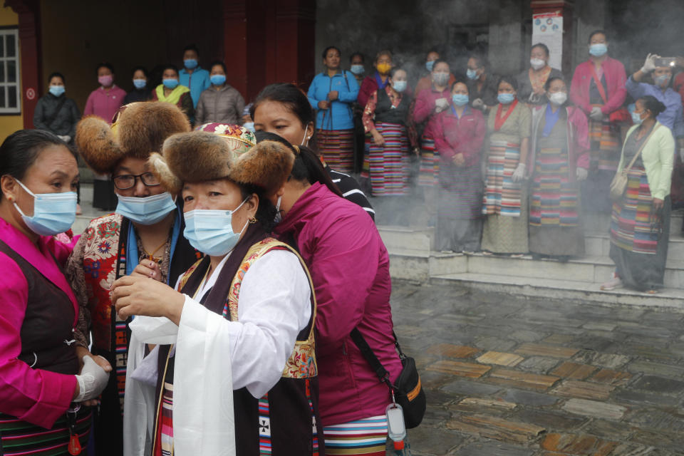 Friends and family members gather for the funeral of veteran Nepalese Sherpa guide Ang Rita, in Kathmandu, Nepal, Wednesday, Sept. 23, 2020. Ang Rita, who was the first person to climb Mount Everest 10 times has died Monday at age 72 after a long illness. (AP Photo/Niranjan Shrestha)