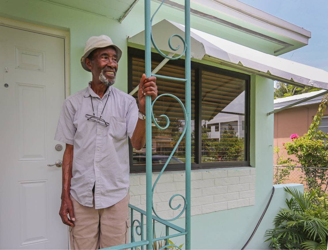 Wilson Williams, 90, a retired Sears maintenance worker, poses on the porch of his longtime home in Miamis historically Black West Coconut Grove on Wednesday, June 15, 2022. The nonprofit group Rebuilding Together is installing new impact windows at Williams’ house.