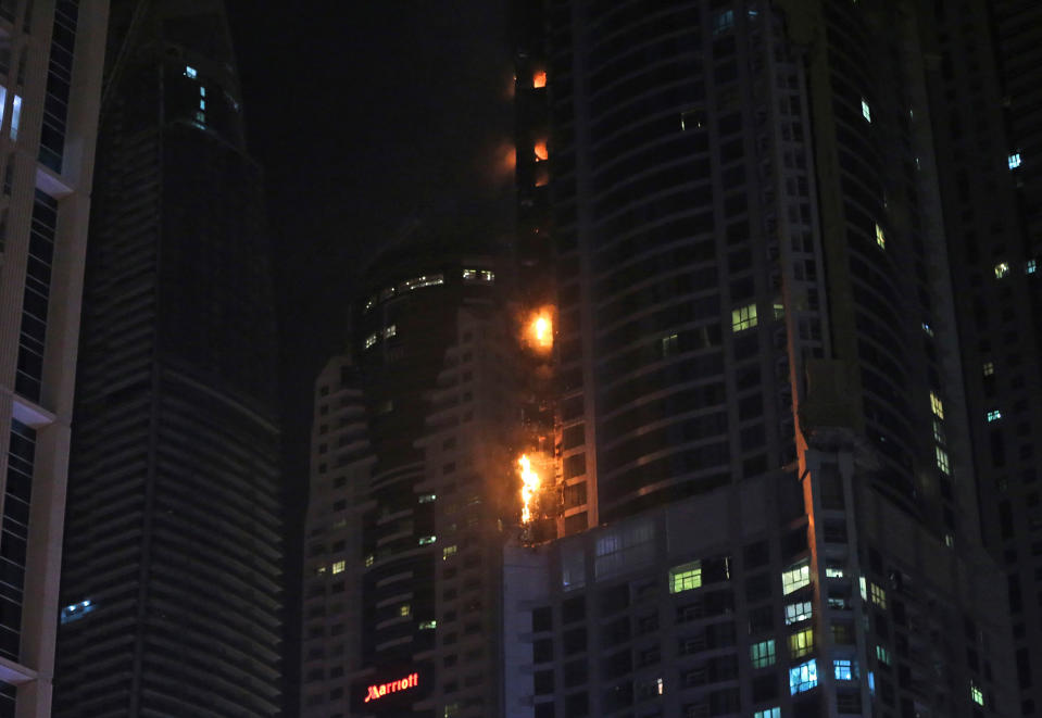 <p>Smoke and fire rise from a high rise building at Marina district in Dubai, U.A.E., Friday, Aug. 4, 2017. (Photo: Kamran Jebreili/AP) </p>